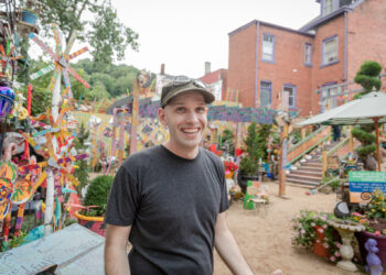 Foo stands in the Randyland courtyard.