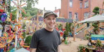Foo stands in the Randyland courtyard.